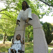 Monumental bronze memorial sculpture of Sami McDonald with statue of Jesus swinging her, Cavehill Cemetery commemorative portrait bronze by Christian Sculptor Tom White.  Children and Jesus sculptures in lifesize and monumental bronze, sculptures of Christ