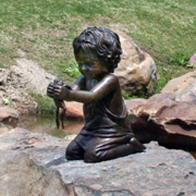 Lifesize portrait bronze memorial sculpture of little boy with a frog placed in the Children's Park Tyler, Texas, family and public monumental sculptures scenes by Tom White, monumental bronze sculptor, figurative portrait bronze memorials, sculptures of children playing, bronze portrait statues of children